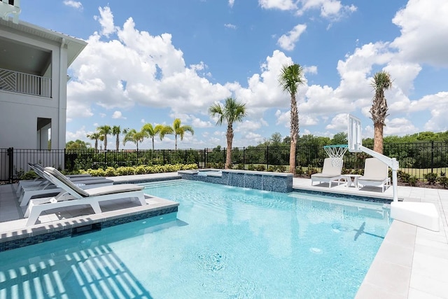 view of swimming pool featuring an in ground hot tub and a patio area