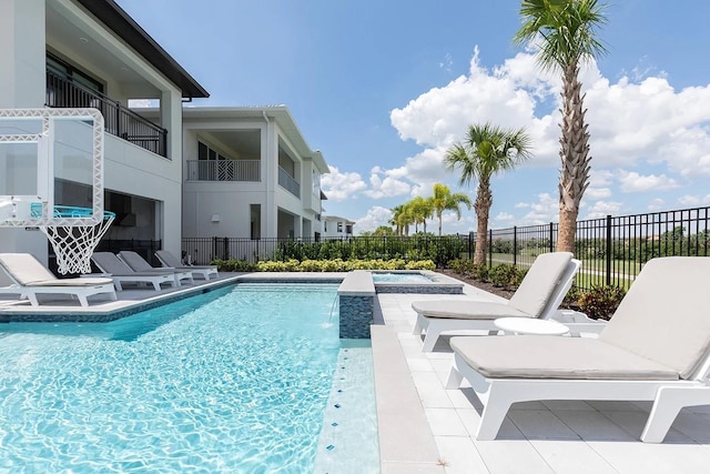 view of pool with a patio and an in ground hot tub