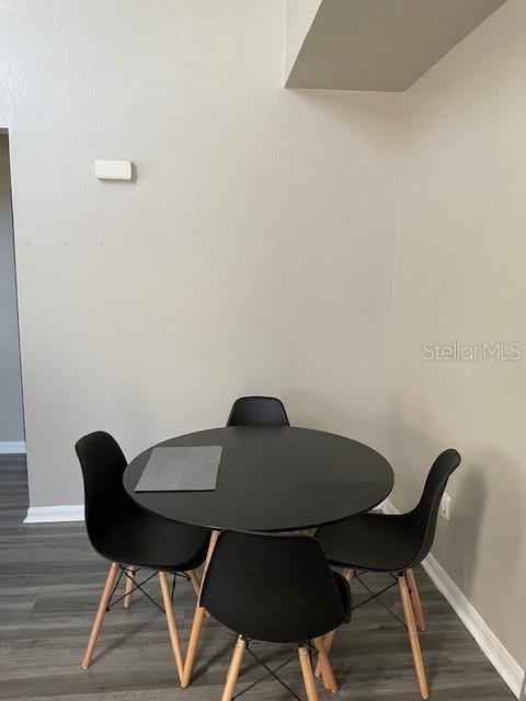 dining area featuring dark hardwood / wood-style flooring