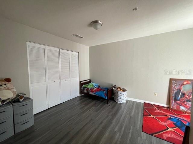 bedroom with a closet and dark wood-type flooring