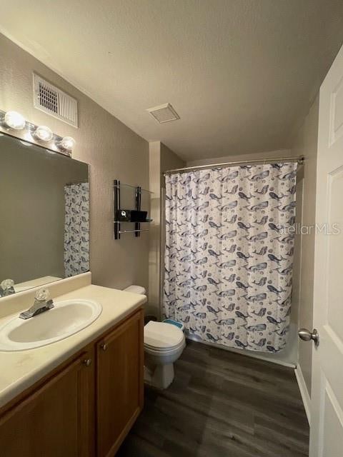 bathroom with vanity, wood-type flooring, and toilet