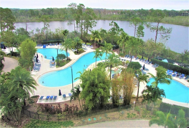 view of swimming pool with a water view and a patio