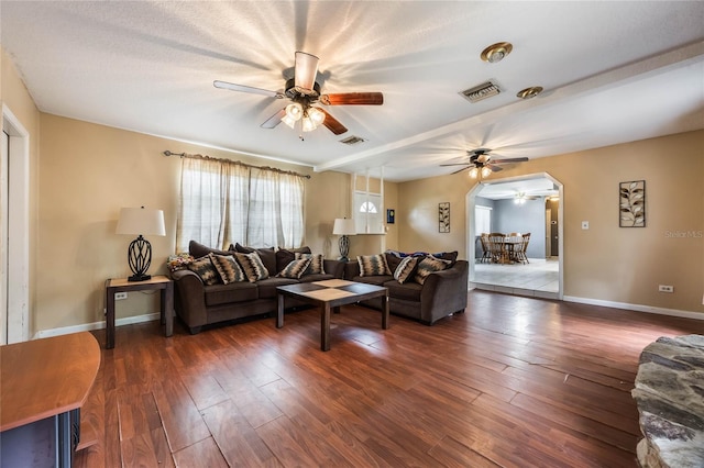 living room with dark hardwood / wood-style floors and ceiling fan