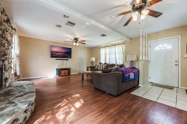 living room featuring hardwood / wood-style floors, ceiling fan, and beamed ceiling