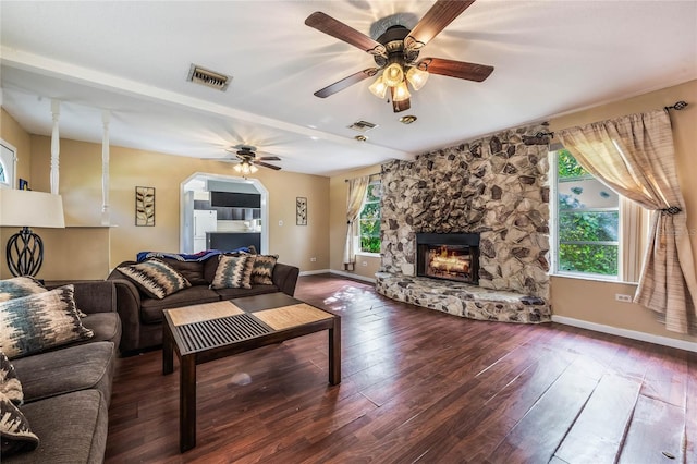 living room featuring hardwood / wood-style flooring, ceiling fan, and a fireplace