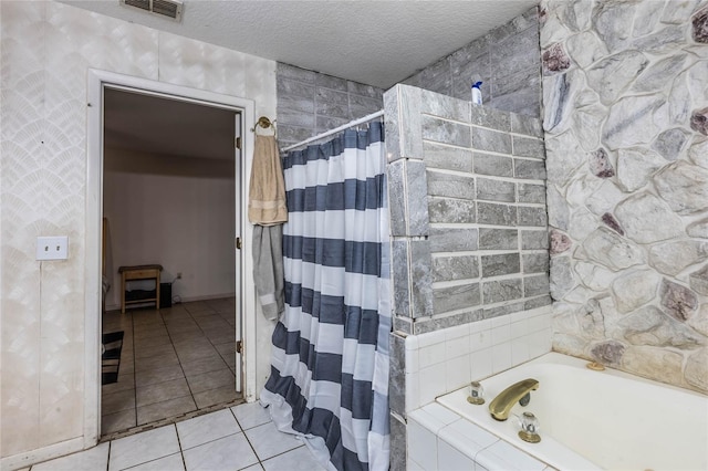 bathroom featuring a textured ceiling and tile patterned floors