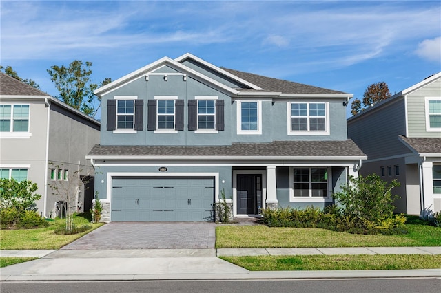 view of front of property with a garage and a front yard