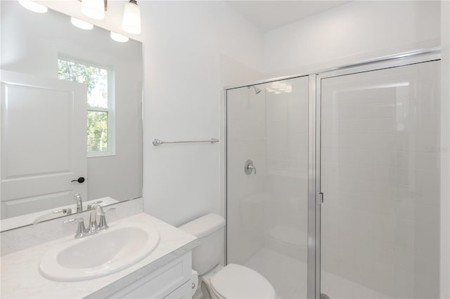 bathroom featuring walk in shower, vanity, and toilet