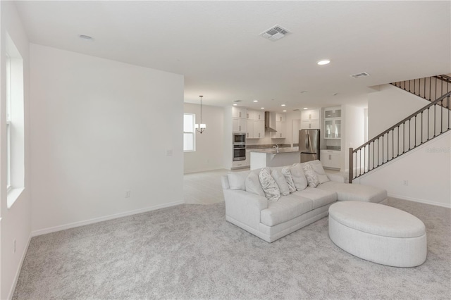5648 Green Arrow Pl, Sanford, FL 32773 - living room featuring stairs, light carpet, baseboards, and recessed lighting