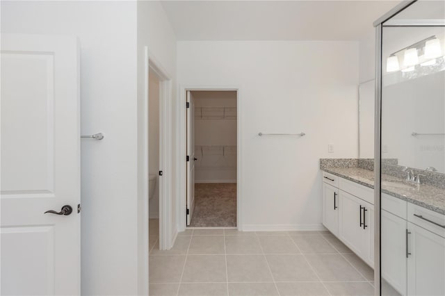 5648 Green Arrow Pl, Sanford, FL 32773 - bathroom with tile patterned flooring, vanity, a spacious closet, and baseboards