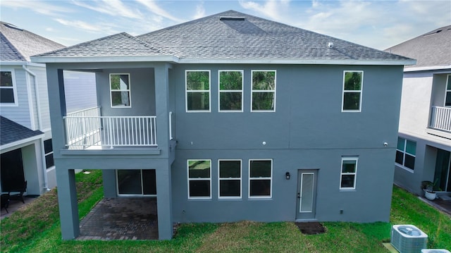 5648 Green Arrow Pl, Sanford, FL 32773 - rear view of property with central AC, a balcony, a yard, and a shingled roof