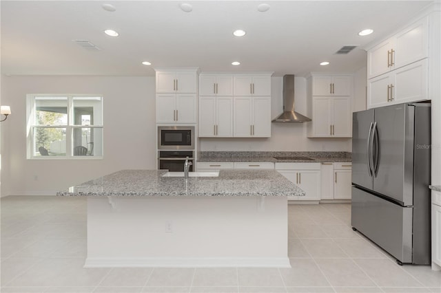 5648 Green Arrow Pl, Sanford, FL 32773 - kitchen with stainless steel appliances, wall chimney exhaust hood, white cabinets, a kitchen island with sink, and recessed lighting