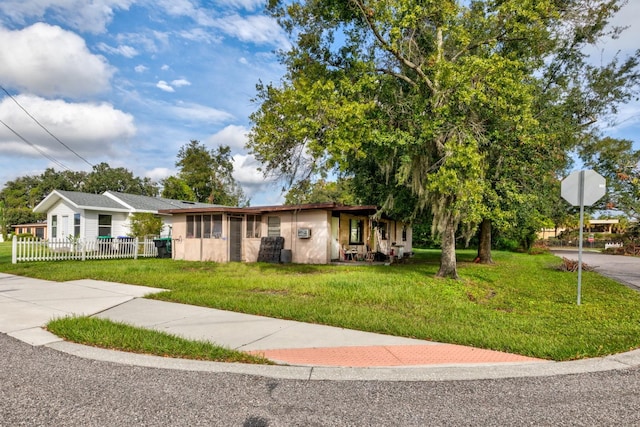 single story home featuring a front lawn