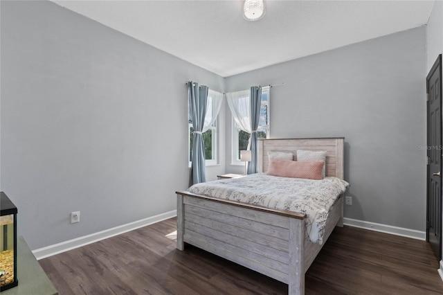 bedroom with dark hardwood / wood-style floors