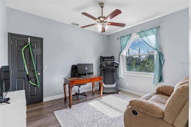 office with ceiling fan and dark wood-type flooring