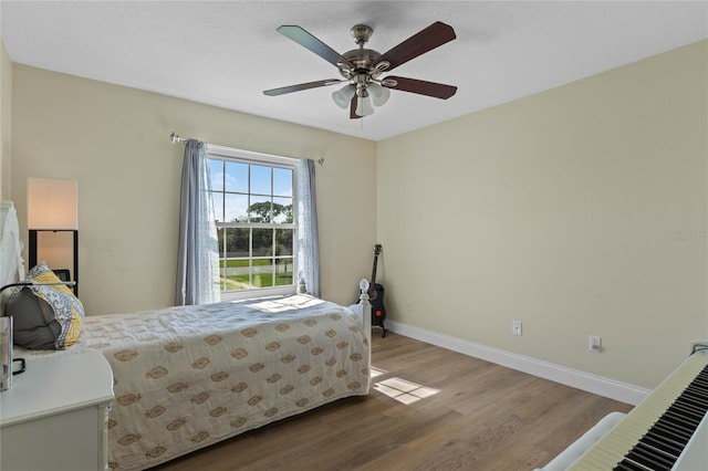 bedroom with ceiling fan and light wood-type flooring