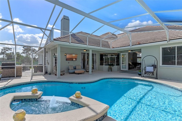 view of pool featuring an in ground hot tub, a patio, ceiling fan, and a lanai