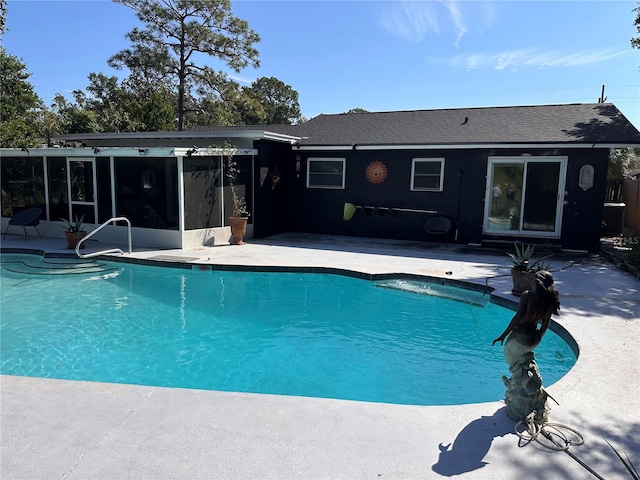 view of pool with a patio area and a sunroom