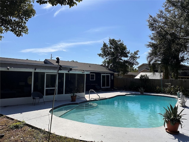 view of pool featuring a sunroom and a patio area