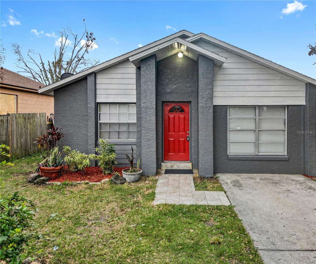 view of exterior entry featuring a yard