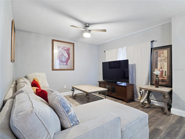 living room featuring dark hardwood / wood-style flooring and ceiling fan