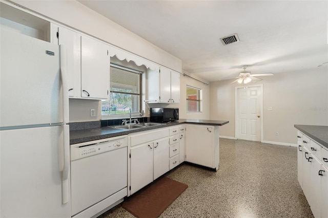 kitchen with white cabinetry, kitchen peninsula, sink, white appliances, and ceiling fan