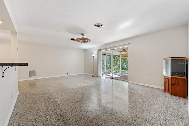 unfurnished living room featuring ceiling fan