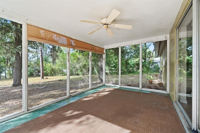 unfurnished sunroom with plenty of natural light and ceiling fan