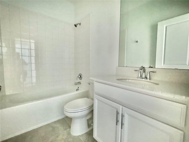 full bathroom featuring tile patterned flooring, toilet, vanity, and tiled shower / bath