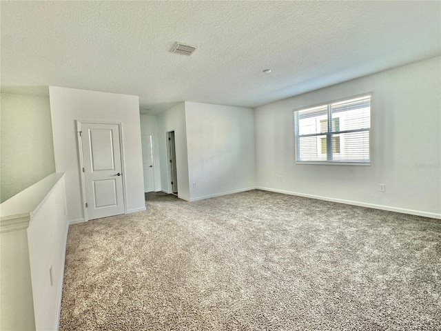 empty room featuring carpet floors and a textured ceiling