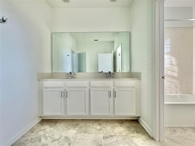 bathroom with vanity and tiled shower / bath