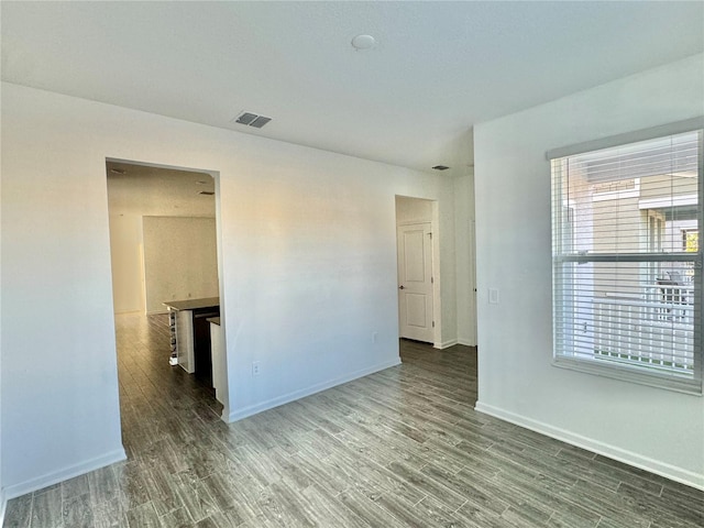 empty room featuring dark wood-type flooring