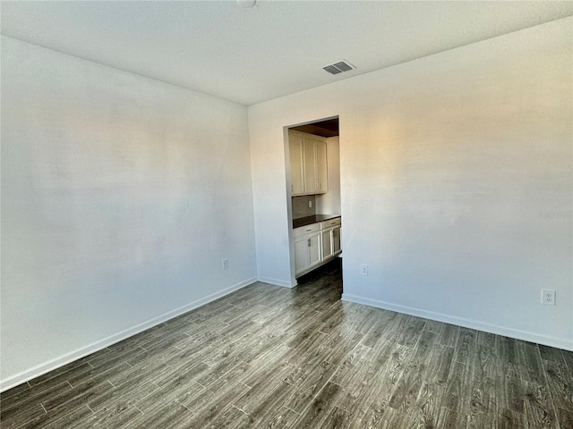 unfurnished room featuring dark hardwood / wood-style floors