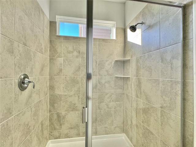 bathroom featuring a shower with door