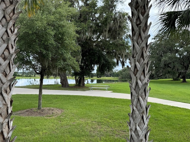 view of property's community featuring a yard and a water view