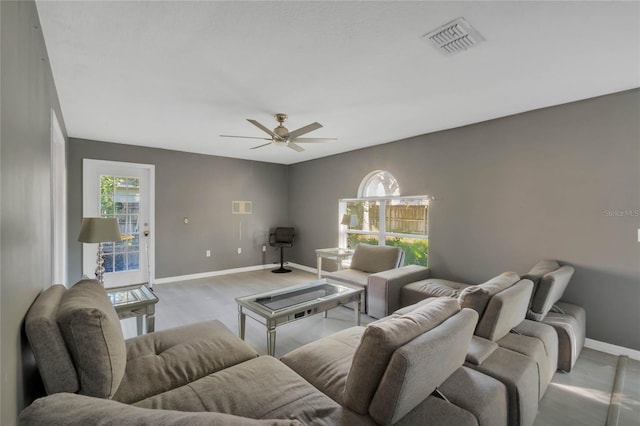 living room featuring ceiling fan and light wood-type flooring