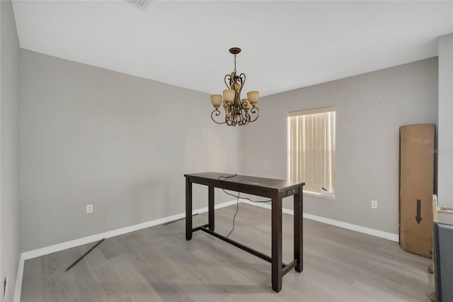 office space featuring hardwood / wood-style floors and a notable chandelier