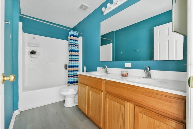 full bathroom with shower / bath combo, toilet, wood-type flooring, and vanity