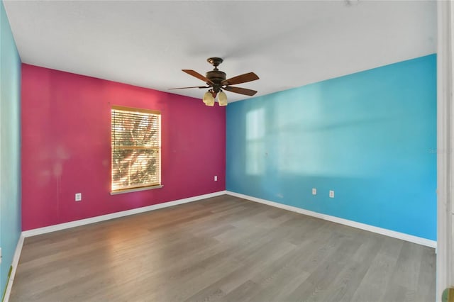 spare room with hardwood / wood-style flooring and ceiling fan