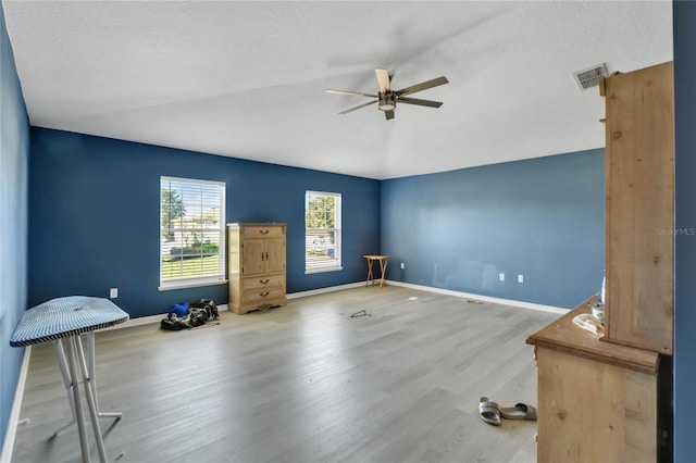 unfurnished room featuring ceiling fan, hardwood / wood-style floors, and a textured ceiling