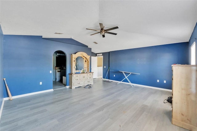 unfurnished living room featuring light wood-type flooring, ceiling fan, and lofted ceiling