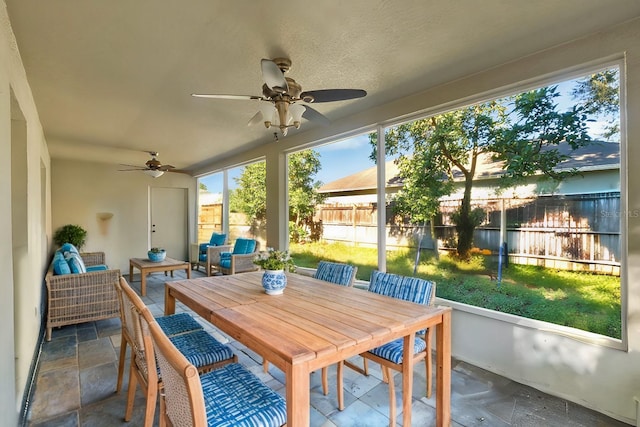 sunroom with ceiling fan