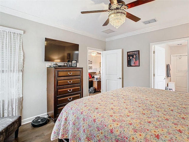 bedroom featuring hardwood / wood-style flooring, ensuite bath, ceiling fan, and ornamental molding