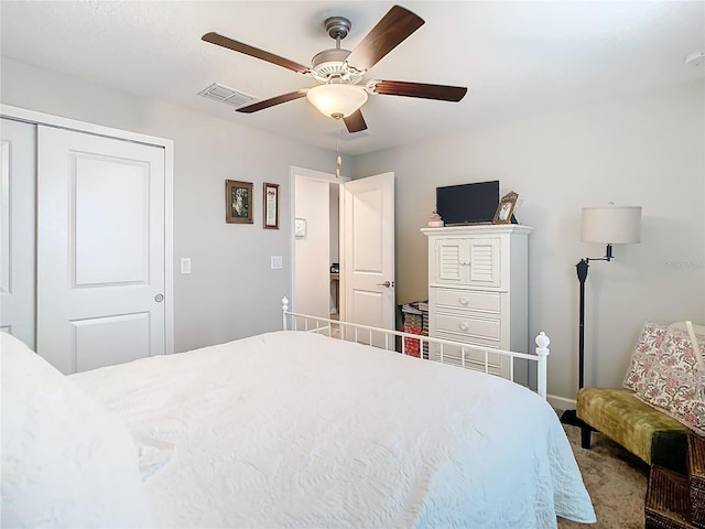 bedroom with ceiling fan, carpet floors, and a closet