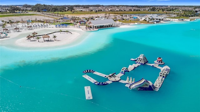 birds eye view of property featuring a beach view and a water view