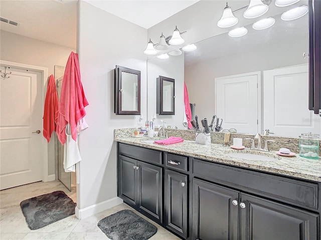 bathroom featuring tile patterned flooring and vanity