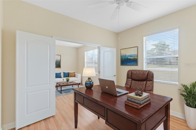 office space with ceiling fan, a healthy amount of sunlight, and light wood-type flooring