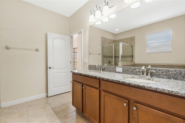 bathroom featuring vanity, a shower with shower door, and tile patterned flooring