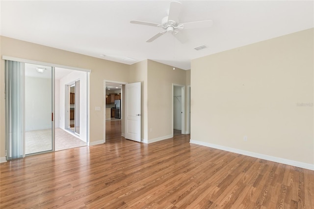 unfurnished room with ceiling fan and light hardwood / wood-style floors