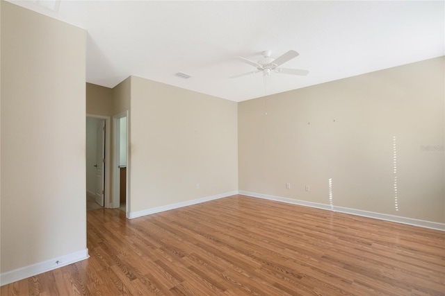 empty room with ceiling fan and light hardwood / wood-style floors